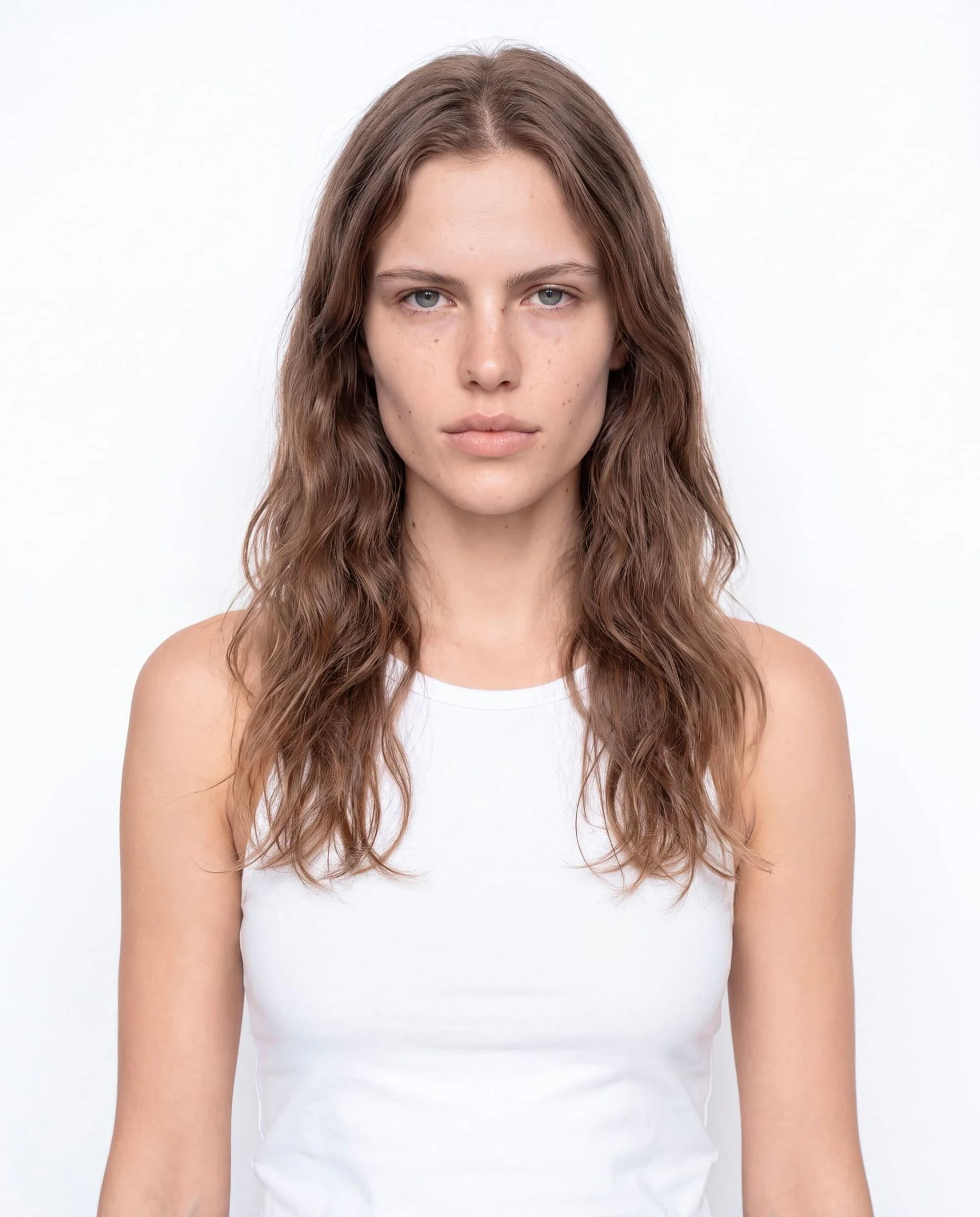 Virtual model, woman with long wavy light-brown hair, in a white tank top