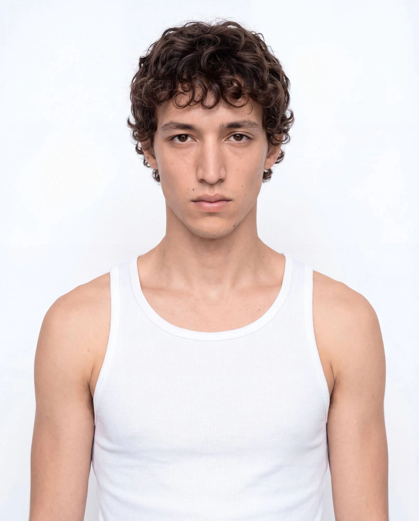 Virtual model, man with brown curly hair, in a white tank top