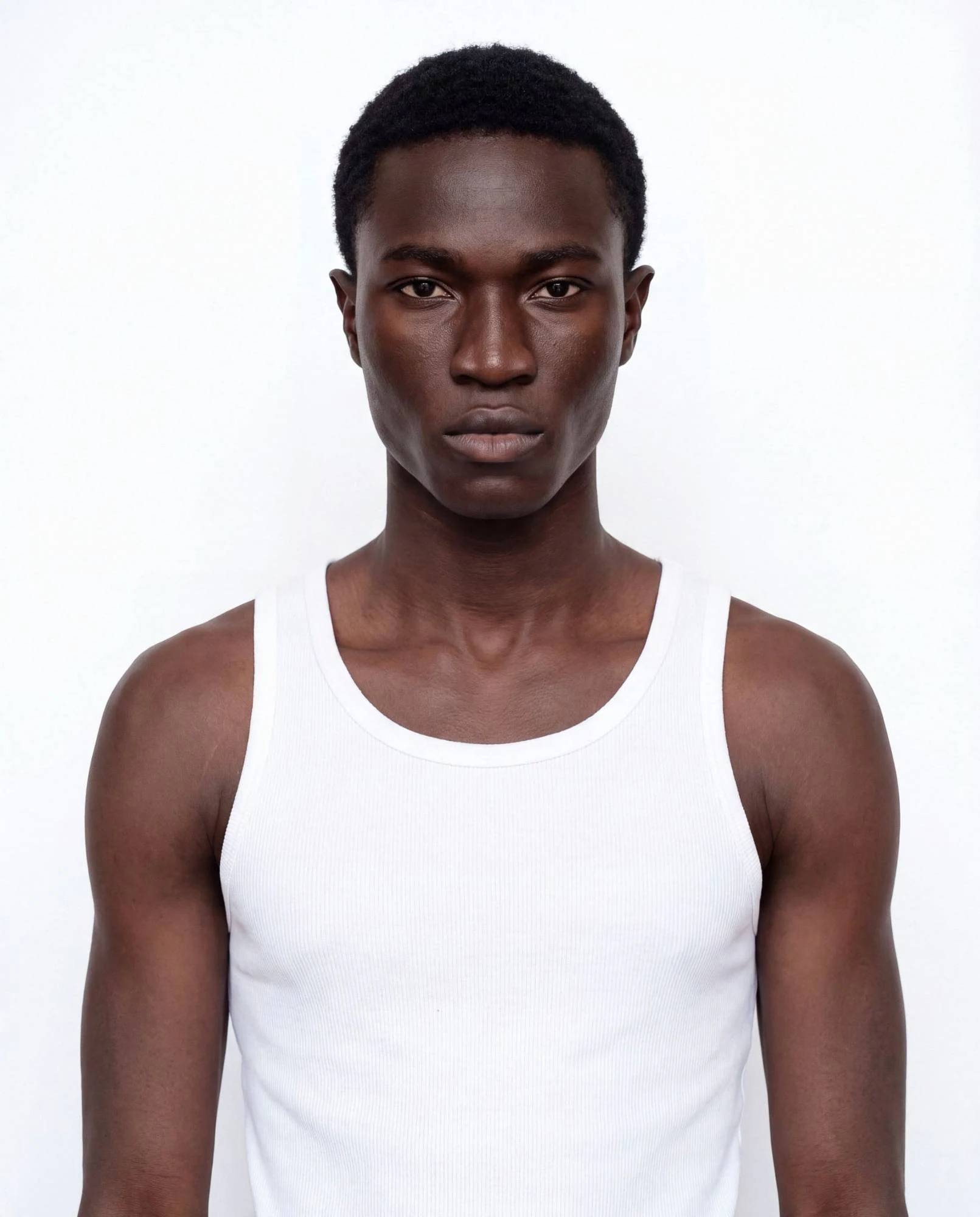 Virtual model, man with black tousled hair, in a white tank top