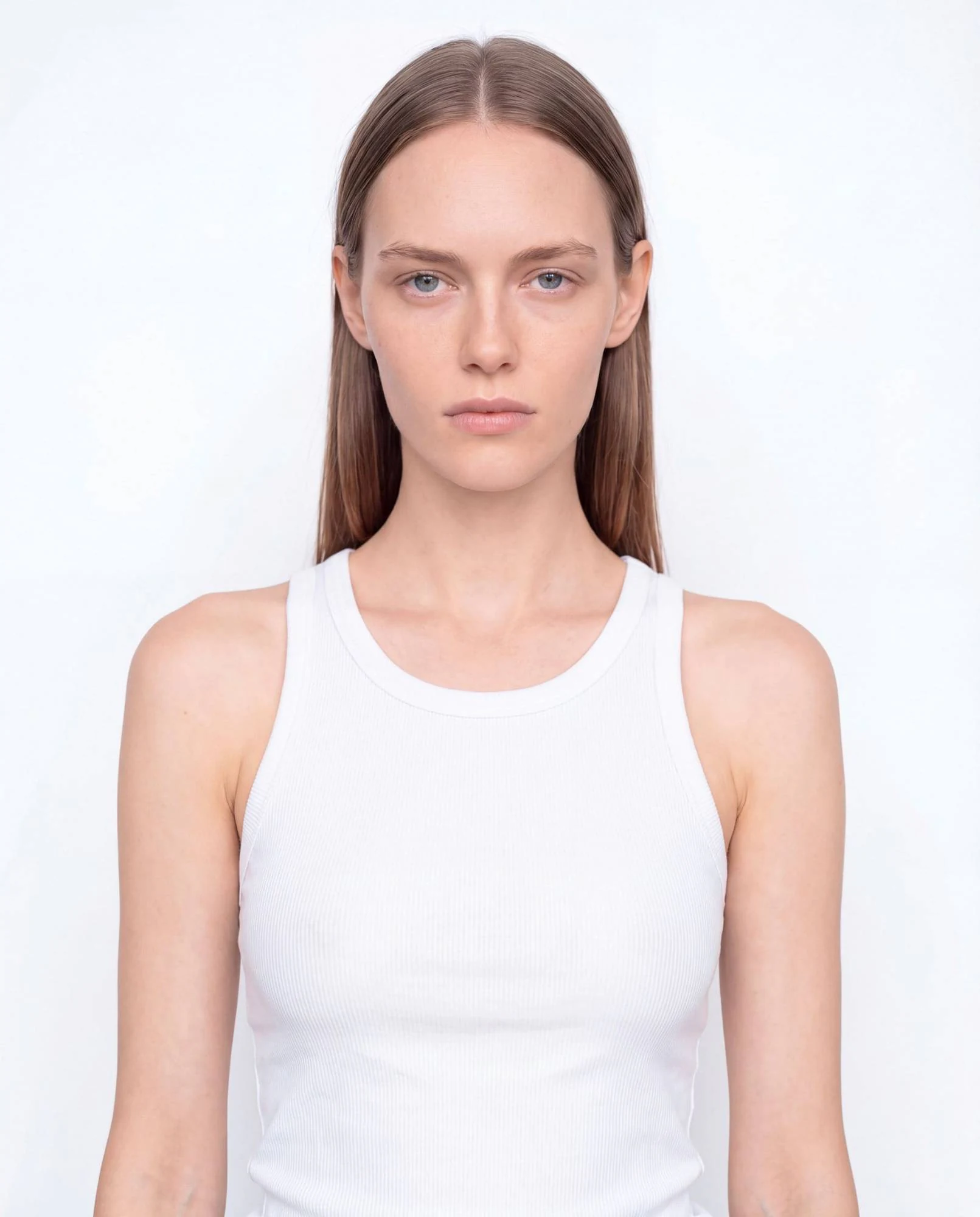 Virtual model, woman with long straight brown hair, in a white tank top