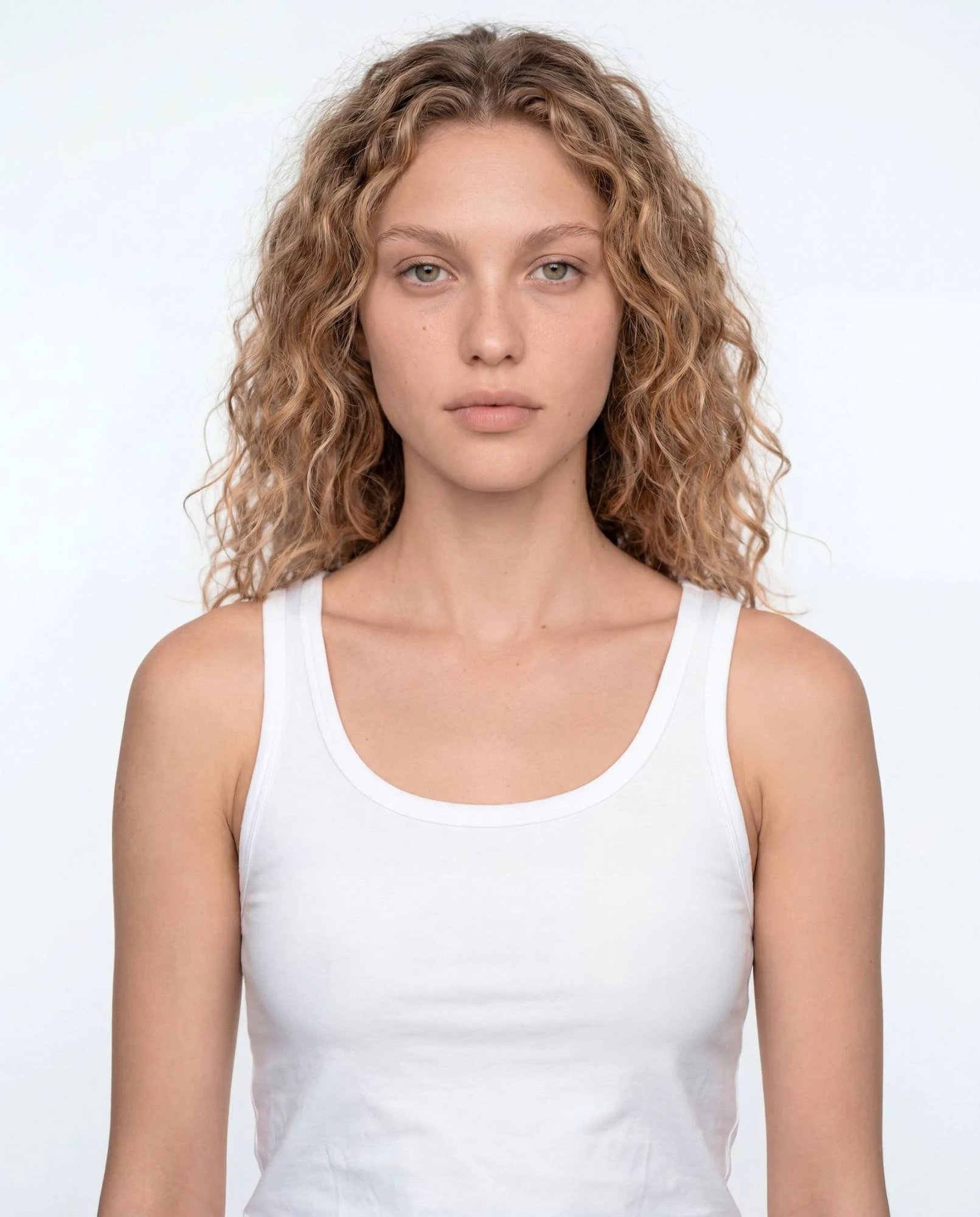 Virtual model, woman with curly blonde hair, in a white tank top