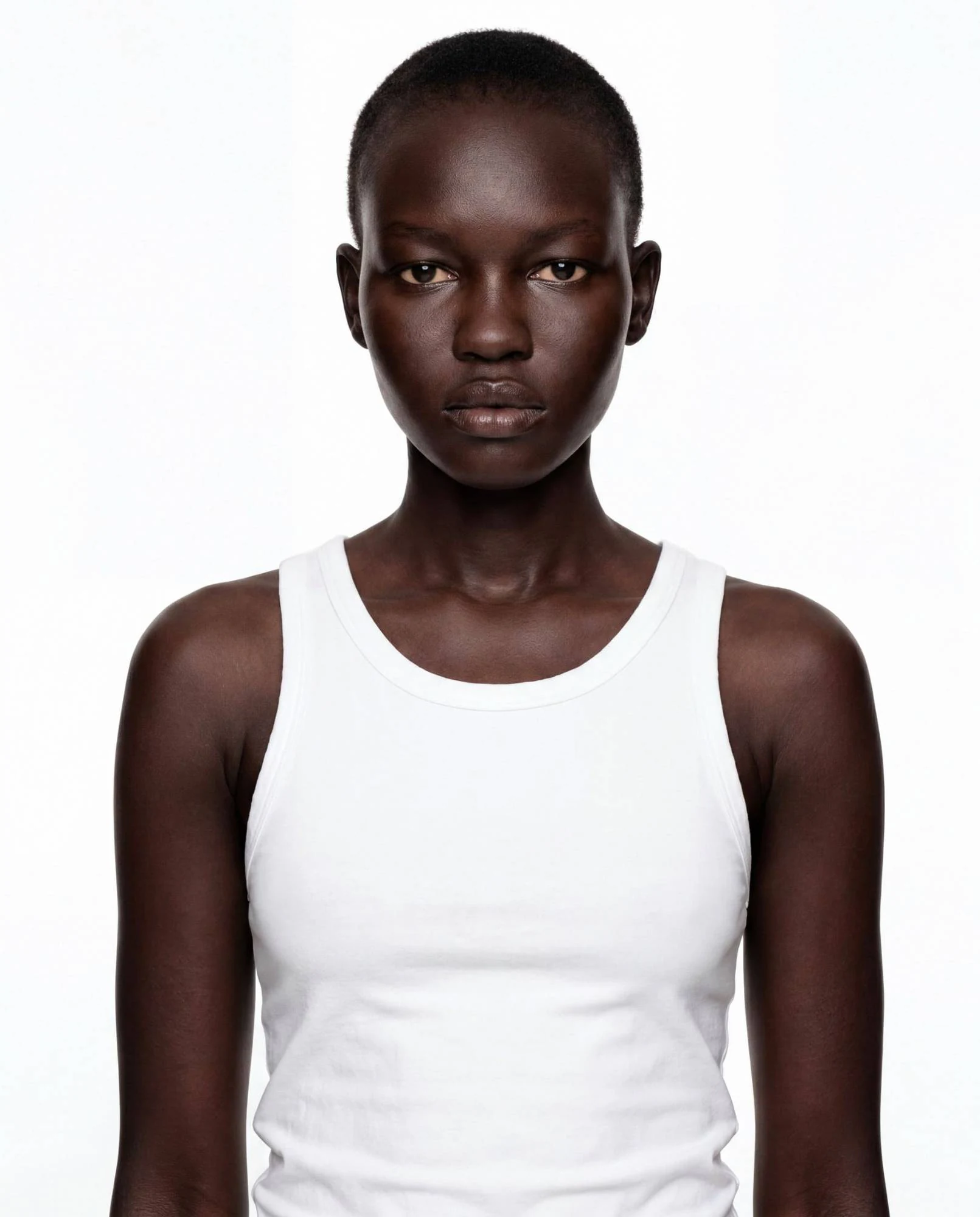Virtual model, woman with a shaved head, in a white tank top