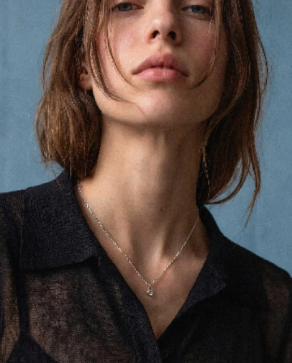 Close portrait of a model wearing a fine silver necklace