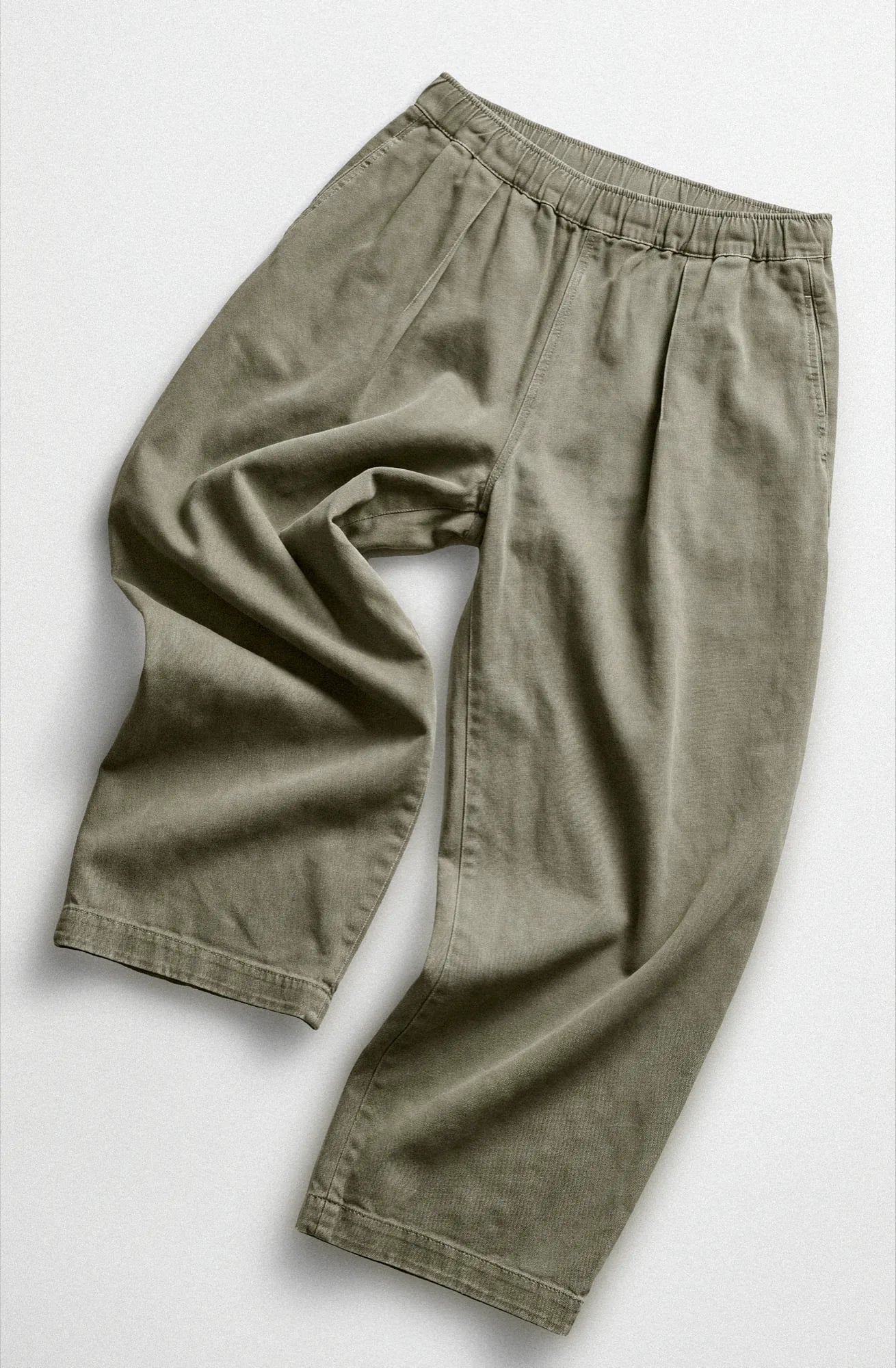 Khaki pull-on trousers laid flat