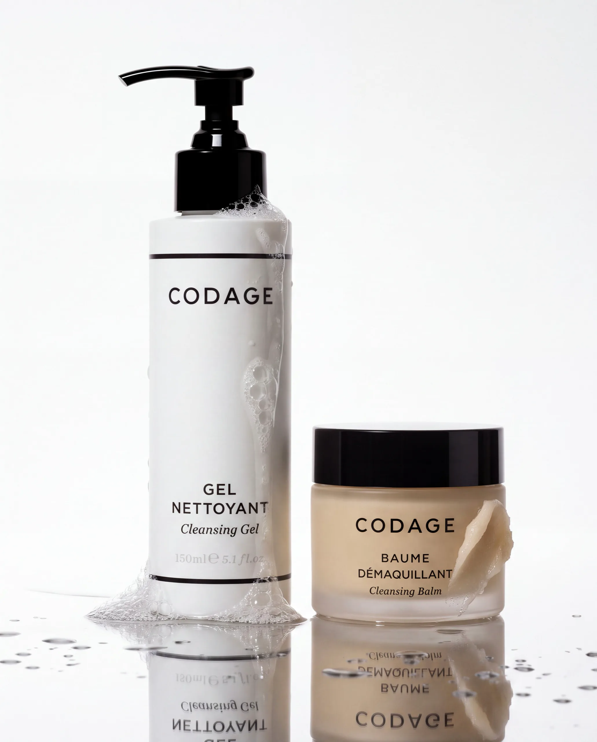 Codage cleansing gel and cleansing balm on a reflective white surface with water droplets