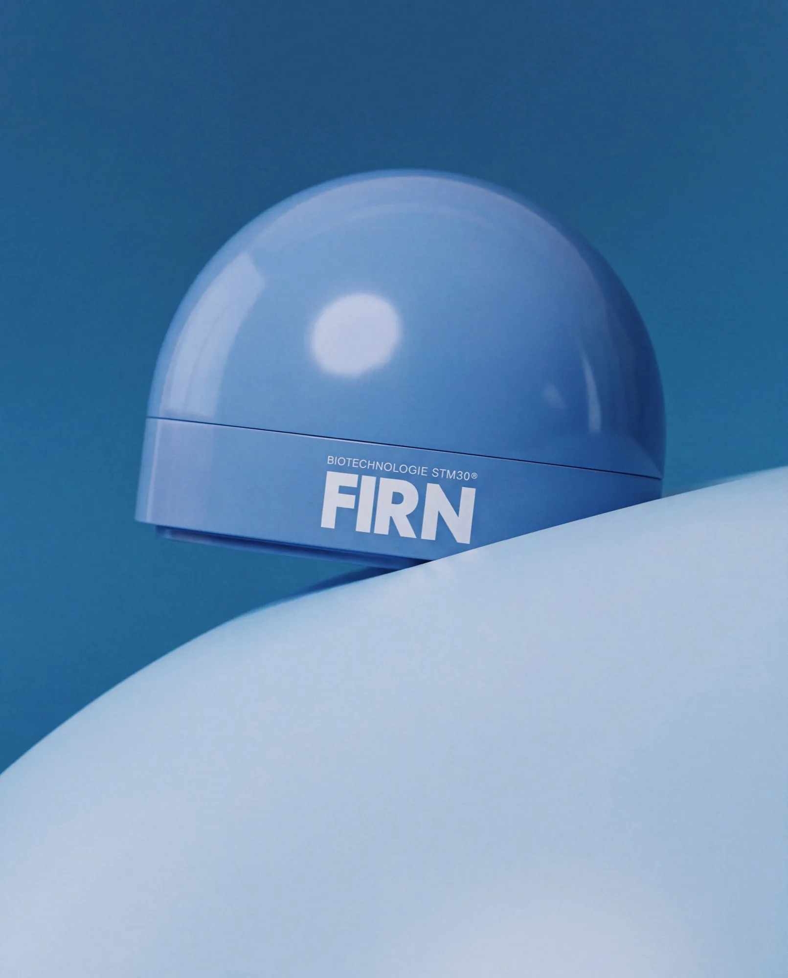Blue Firn skincare jar on a curved pale blue surface