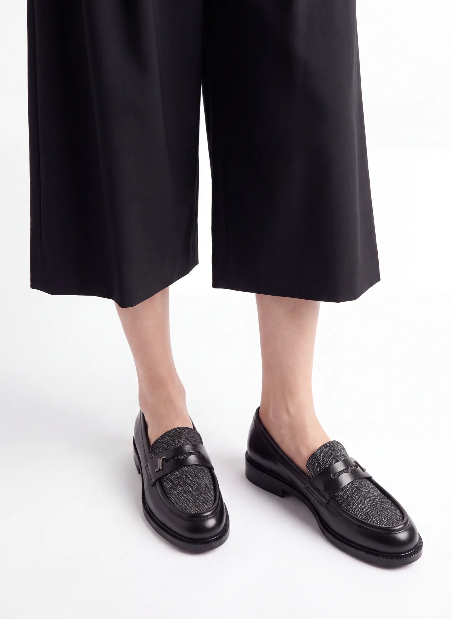 Black loafers worn with black culottes